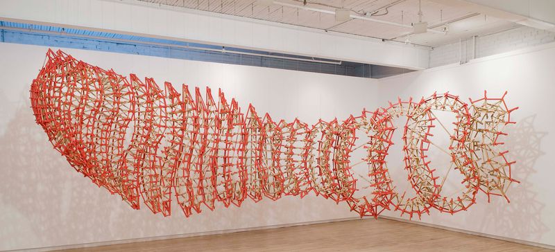 A large wooden hanging installation titled Nimbus by Stephen Talasnik.